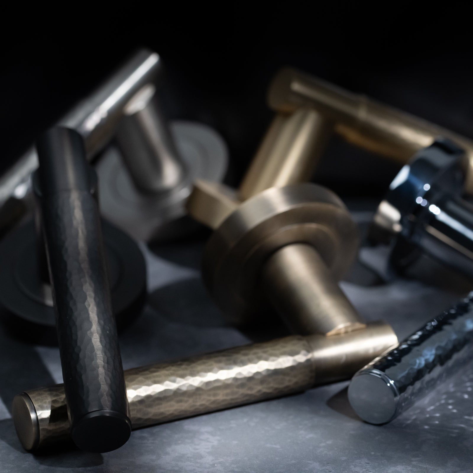 Hammered lever on rose door handle in antique brass finish with hidden fixings