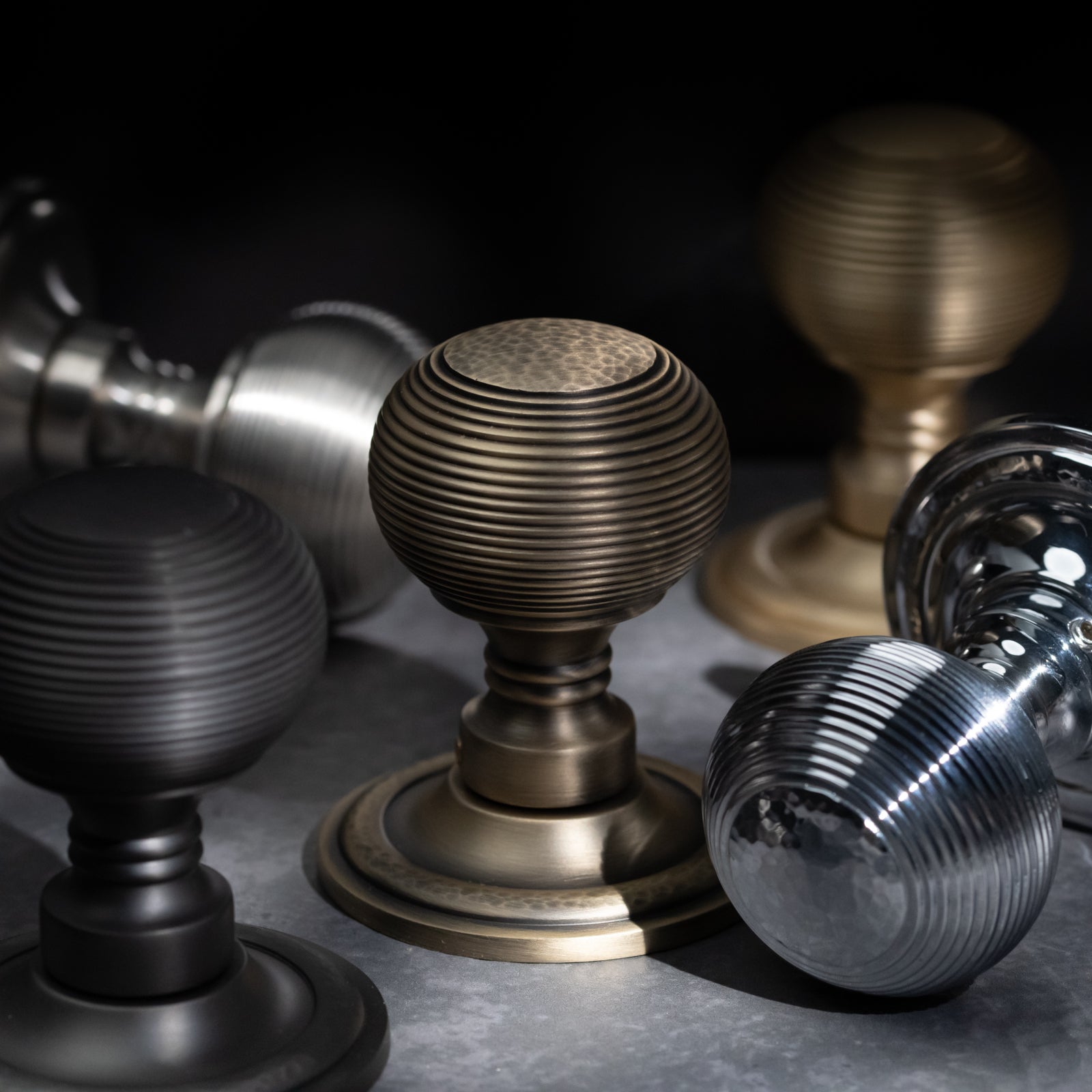 Hammered reeded brass door knob with traditional profile and antique brass finish